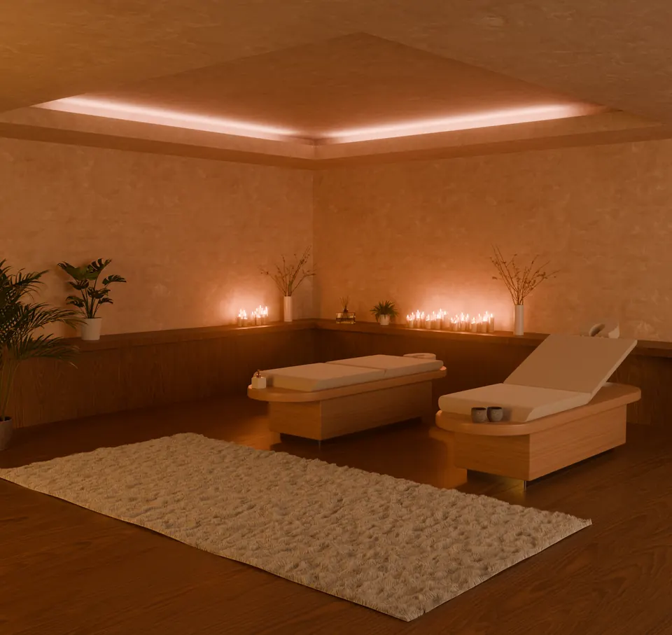 Minimalistički spa prostor s masažnim ležajevima i toplom skrivenom rasvjetom.